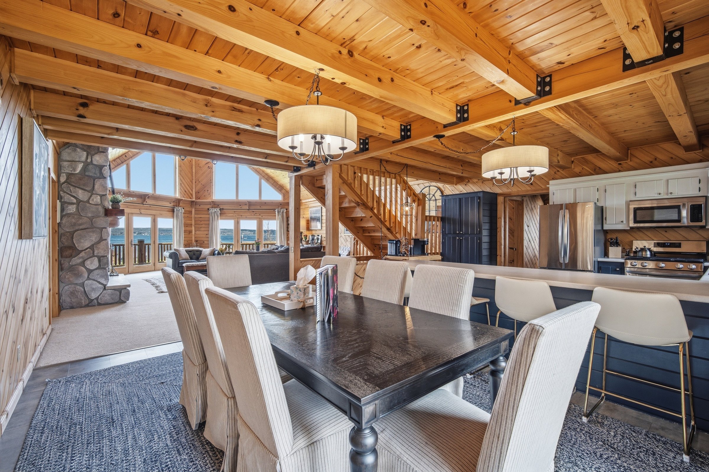 Dining table with great room and lake beyond