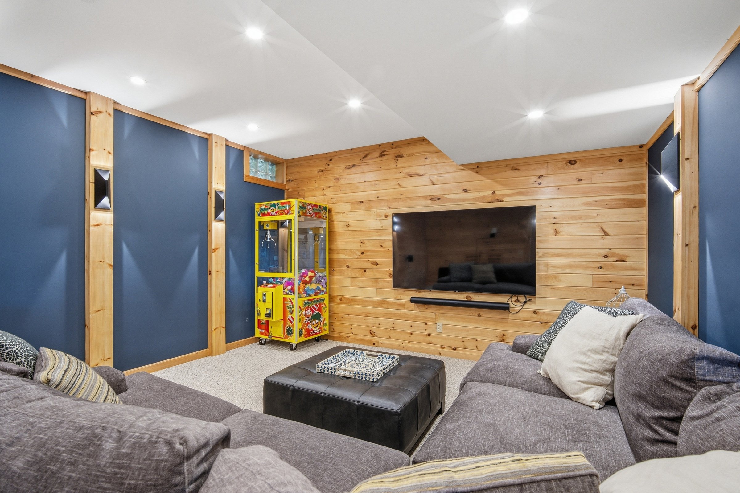 Media and game room with sectional and arcade